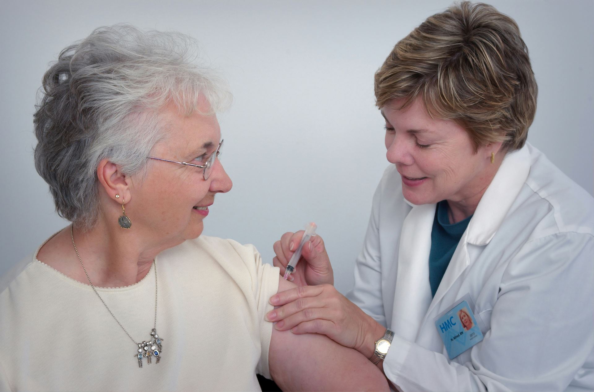 Doctor assisting elderly lady